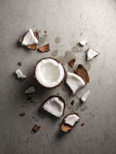 some pieces of coconut sitting on top of a table next to a sign that says why oil pulling will be your new bff