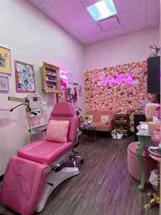 a room with pink chairs and pictures on the wall