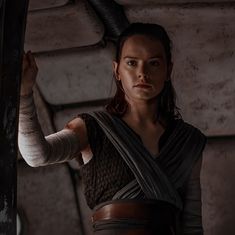 a woman in a star wars outfit holding an arm