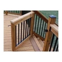 a wooden deck with black iron railings