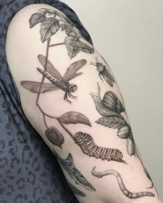 a woman's arm with dragonflys and flowers on the left side of her body