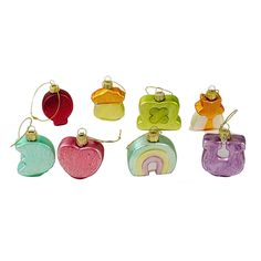 six different shaped glass ornaments in various colors and shapes, each with a rainbow design