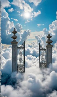 two gates surrounded by clouds with the sky in the background and sun shining through them