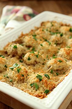 a casserole dish with meat and cheese in it on a wooden table top