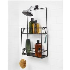 a bathroom shelf with soap and lotion on it next to a wall mounted shower faucet