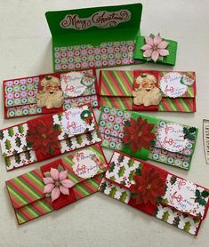 christmas cards with santa and poinsettis on them are laid out next to each other