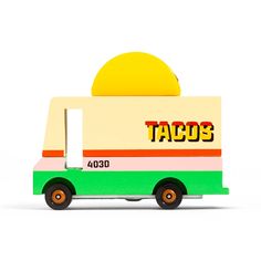 a taco truck toy is shown on a white background with the word tacos painted on it