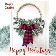 a christmas wreath with red and black plaid bow hanging on the front door for baka crafts