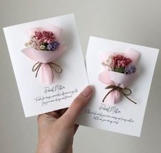 two handmade greeting cards with flowers on them, one is pink and the other is white