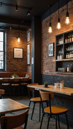 the interior of a restaurant with wooden tables and chairs, exposed brick walls and hanging lights