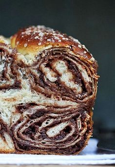 a loaf of cinnamon roll sitting on top of a white plate