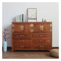 a wooden dresser with brass handles and drawers