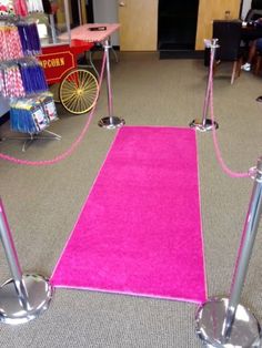 a pink carpet with two metal poles on each side and a pink rug on the other