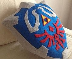 a blue and white pillow with an image of the legend of zelda on it