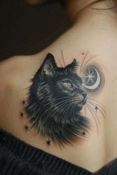 a woman's shoulder with a black cat and crescent moon tattoo on her left shoulder