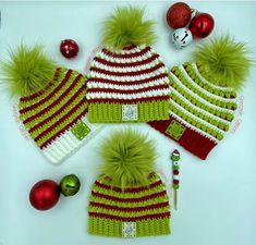 three knitted hats and ornaments on a table