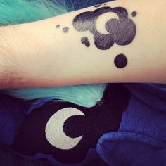 a person's arm with a black ink design on the left side of their arm