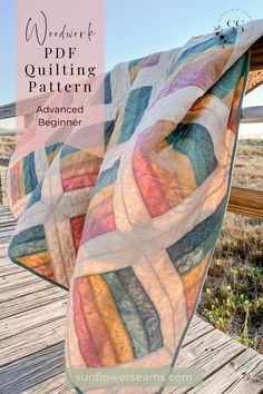 a quilted blanket sitting on top of a wooden deck next to the ocean with text overlay that reads, we heart pdr quilting pattern advanced beginner