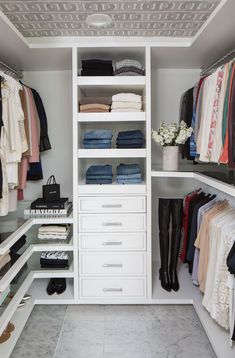 an organized closet with clothes and shoes on the shelves, along with other items in it