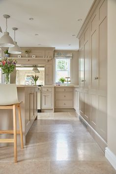 a large kitchen with an island and bar stools