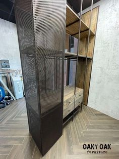 a room divider in the middle of a wood floor with shelves and drawers behind it