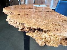 a wooden table with blue chairs around it