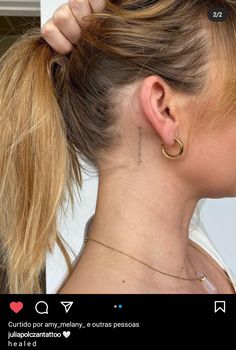 a woman with her hair in a pony tail styled up into a ponytail and wearing gold hoop earrings