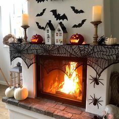 a fireplace decorated for halloween with pumpkins and spiderweave decorations on the mantle