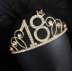 a gold tiara with the number eighteen on it's side and surrounded by diamonds