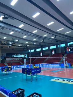 an indoor volleyball court with tables and chairs