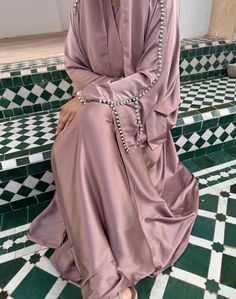 A stunning and luxurious abaya featuring pearl and diamanté detailing along the sleeves. Comes with: Outer abaya, Inner Dress, Hijab, Belt Colour may vary due to device settings. Check size guide before placing order. Dry clean only. Modest Wedding Niqab For Eid, Elegant Long Sleeve Wedding Niqab, Modest Style Khimar For Wedding And Eid, Elegant Maxi Length Niqab For Eid, Long Khimar For Wedding, Elegant Long Niqab For Eid, Long Khimar For Wedding Eid Festival, Long Khimar For Wedding And Eid, Floor-length Wedding Khimar With Dabka