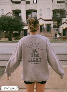 ✨Be the light Christian bible verse sweatshirt Jesus Hoodie Aesthetic Christian Sweatshirt Women's Religious Shirt Bible Verse Shirt Christian Gifts For Her Catholic Gifts  ✨ Hey everyone! Welcome to her+em storefront. Here you'll find affordable, long-lasting shirts and sweatshirts all designed by me! These unique designs are the perfect gift for loved ones, friends, family, coworkers, and even yourself. Each order we get is made specifically for you with utmost love and care.  ✨ TO ORDER:  * read the product photos and description to review the product * select the correct size and color from the two drop down menus * click add to cart * if you are done shopping, proceed to checkout accordingly with the correct address. ✨ WASHING: * It's recommended to wash inside out, on cold, with like Jesus Sweatshirts, Matthew 5, Hoodie Aesthetic, Bible Verse Shirt, Be The Light, Retro Sweatshirts, Christian Sweatshirt, He Left, Sweatshirt Cute