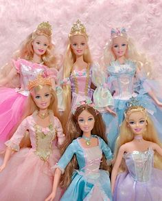 several barbie dolls are posed together in their princess dresses and tiaras for a photo