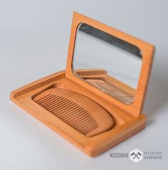 a small wooden box with a mirror on it