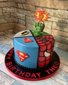 a birthday cake with the theme of spider - man and green spiky fingers