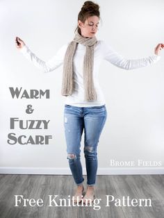 a woman standing in front of a white wall wearing a scarf and jeans with the words warm & fuzzy scarf above her head