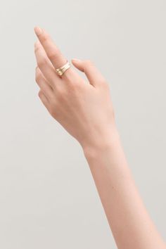 a woman's hand with a gold ring on it