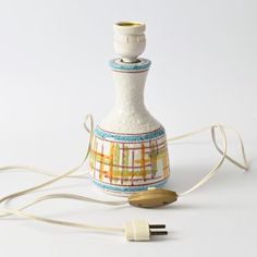 a small bottle with a cord attached to it