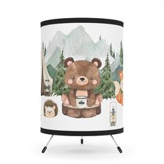 a lamp shade with a bear holding a coffee cup in front of mountains and trees