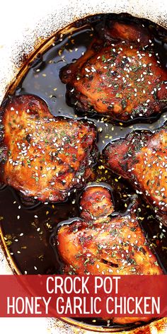 some chicken is cooking in a pan with sauce and seasoning on top that says crock pot honey garlic chicken