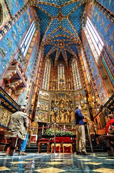 two men are standing in the middle of a church