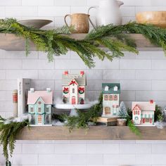 christmas decorations are displayed on shelves in the kitchen