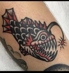 a close up of a tattoo on the arm of a person with a dragon head