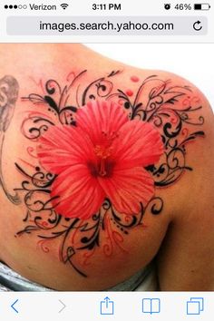 a woman's back with a pink flower on it