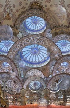 an ornately decorated ceiling in a building with many circular windows and intricate designs on the ceiling