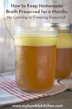 two jars filled with liquid sitting on top of a table