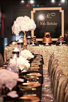 the table is set up for a 30th birthday party with gold sequins and white flowers