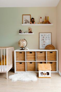 a baby's room with baskets and toys on the floor