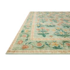 an area rug with flowers and leaves on the top, in pastel green tones