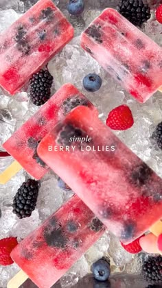 three popsicles with berries and blueberries on ice